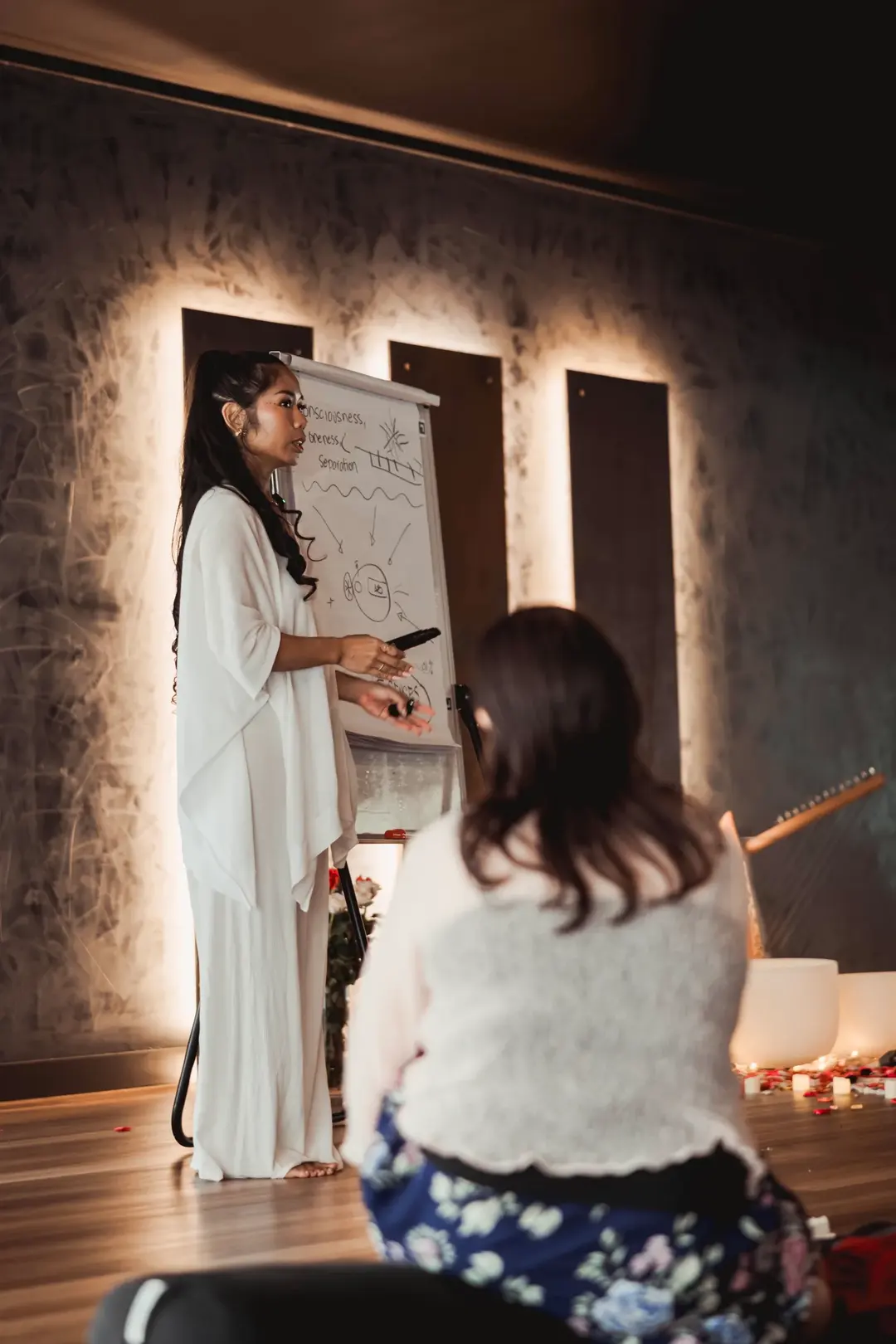 Sarah teaching at the whiteboard during a live workshop